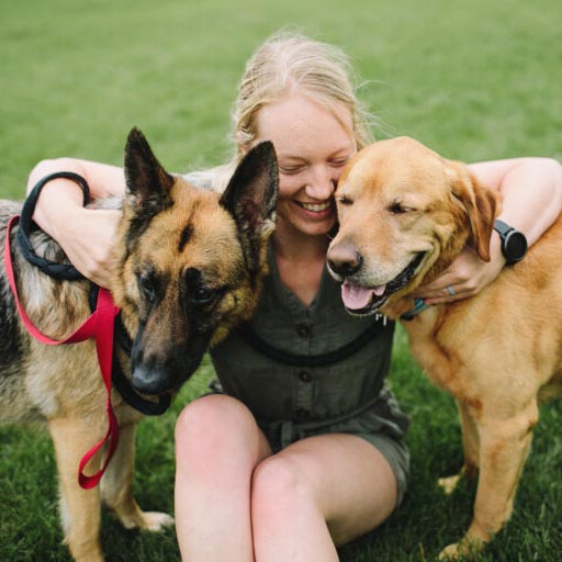 Cassie holding her dogs
