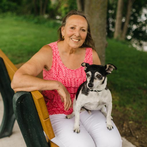 Mary sitting in the park with her dog