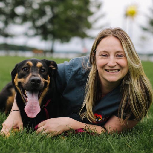 Molly with her dog laying in the grass