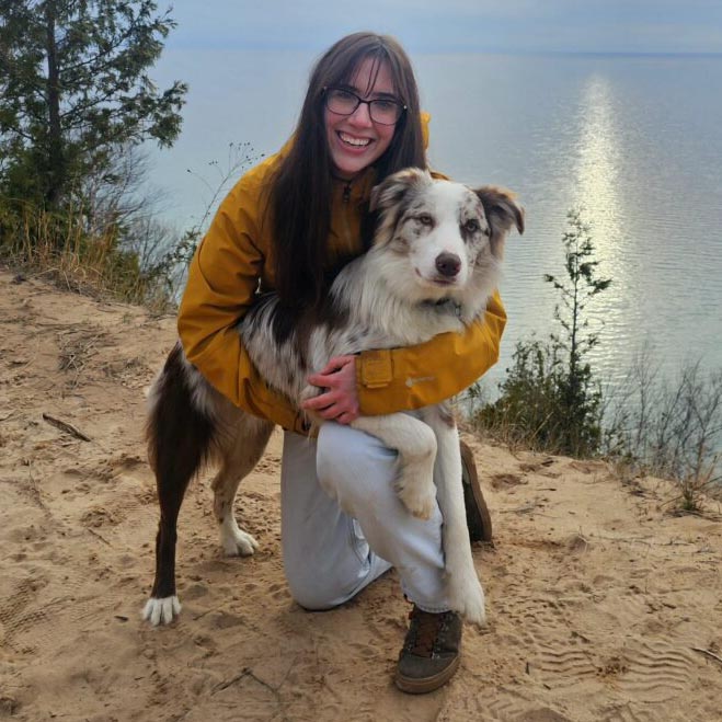 Sarah at the lake with her dog